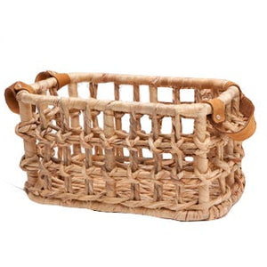 The Small Somerset Basket by Pigeon & Poodle showcases an airy lattice design with sturdy leather handles on each end.