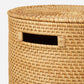 The Nema Hamper by Pigeon & Poodle is a hand-woven rattan hamper with a detachable lid and a rectangular side handle opening for easy carrying.
