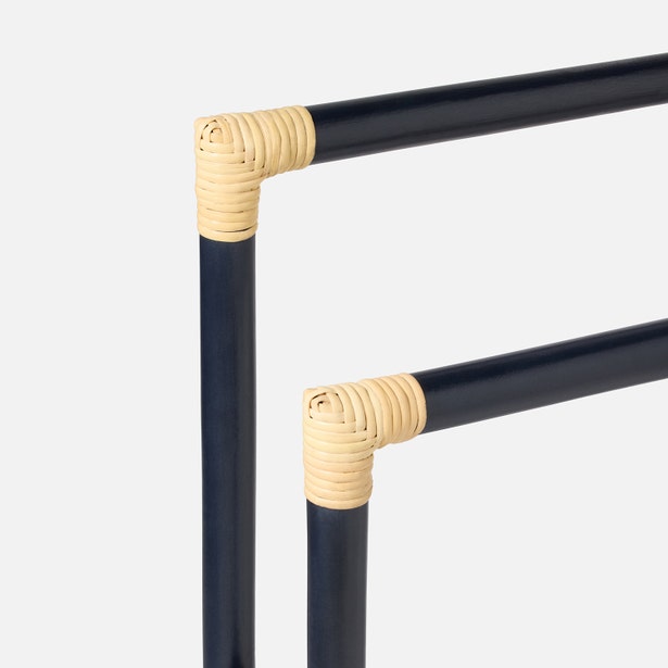 Close-up of two navy metal rods joined at right angles with beige wicker wrapping, highlighting the coastal charm of Pigeon & Poodle’s Bolzano Towel Rack Collection against a plain white background.