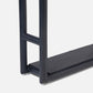 Close-up of the lower section of a modern, dark-finished Bolzano Towel Rack from Pigeon & Poodle, featuring tubular legs and a flat base shelf, offering subtle coastal charm against a white background.