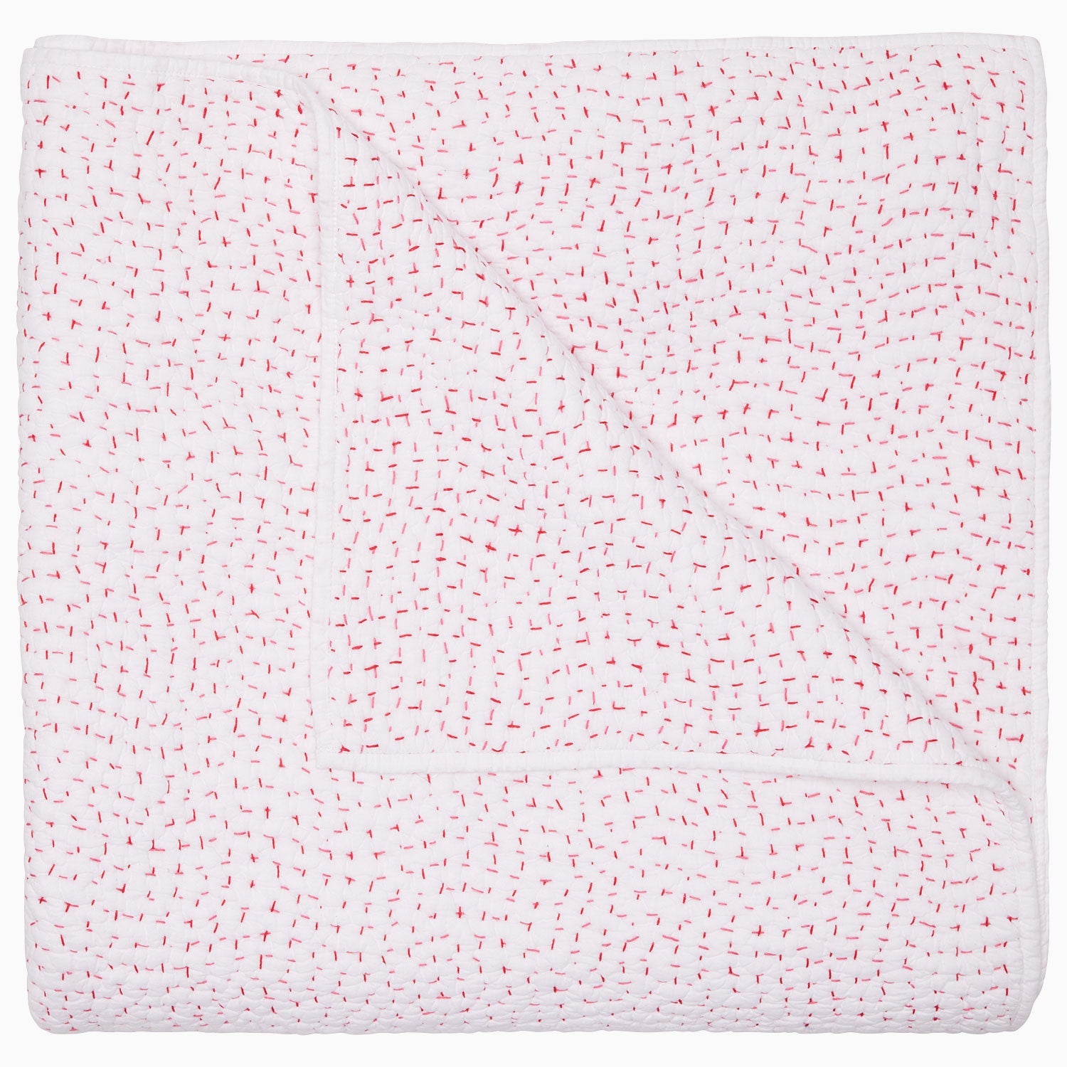 A folded white coverlet from the Hand-Stitched Bedding Collection by John Robshaw, crafted from soft organic cotton and featuring a subtle pattern of evenly spaced small red stitches, is displayed on a plain background.