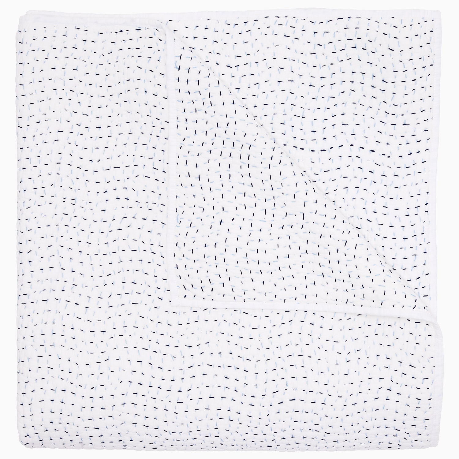 A folded white coverlet from the John Robshaw Hand-Stitched Bedding Collection, featuring small, evenly spaced black stitches in a wavy pattern across soft cotton voile fabric.