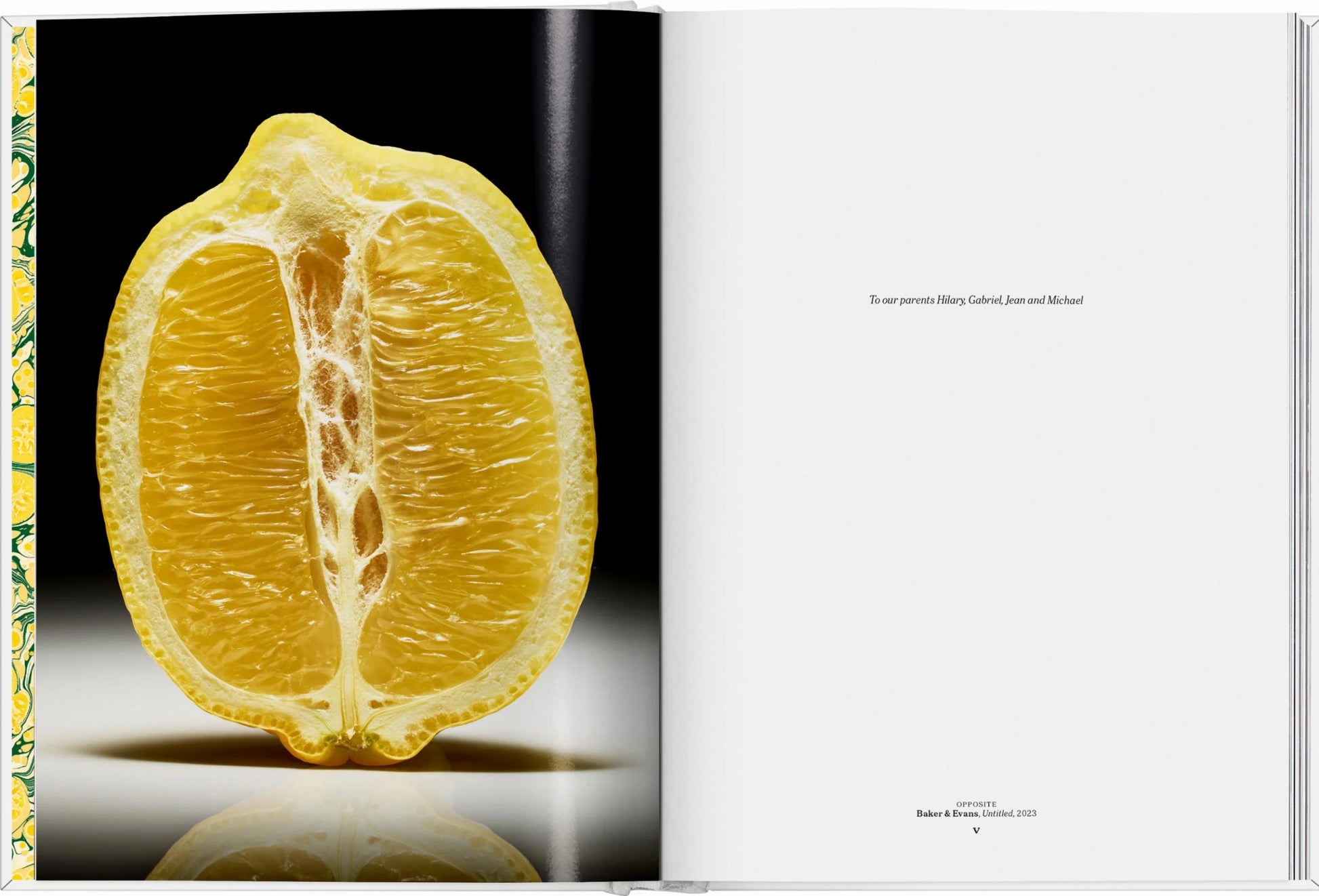 On the left page of "The Gourmand's Lemon: A Collection of Stories and Recipes" by Taschen, a halved lemon spotlights its unique food-art fusion; the right presents a brief dedication on a plain white background.