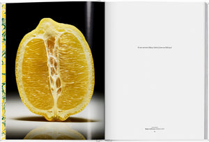 On the left page of "The Gourmand's Lemon: A Collection of Stories and Recipes" by Taschen, a halved lemon spotlights its unique food-art fusion; the right presents a brief dedication on a plain white background.