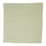 The Juliska Berry Trim Napkin Collection features a plain, light green woven cotton napkin with a fine stitched border, shown laid flat against a white background.