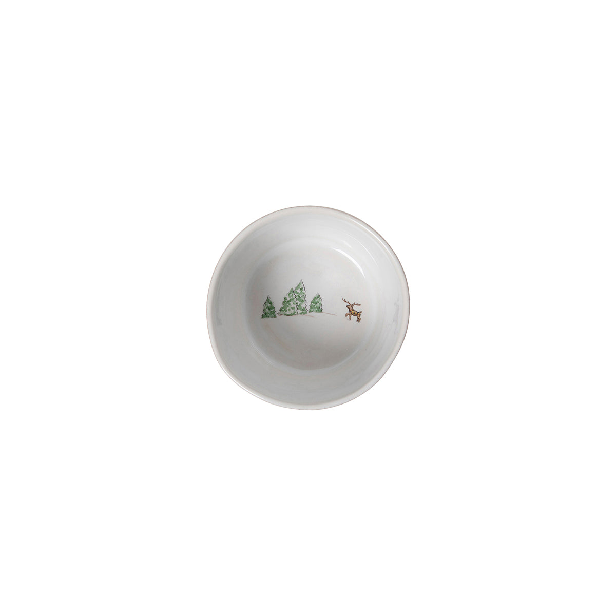 Add festive charm to your Christmas table with the Juliska Berry & Thread North Pole Dinnerware, featuring a white ceramic bowl adorned with green trees and a brown reindeer.