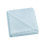 The Gooselings Cotton Knit Baby Blanket in light blue, made from 100% cotton with scalloped edges, is folded and shown on a white background—an ideal soft addition to any nursery.