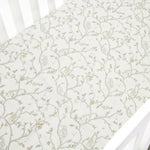 The Gooselings Animal Parade Ivory Crib Sheet is an extra soft cotton sateen sheet for crib mattresses, featuring a delicate pattern of neutral-tone animal designs.
