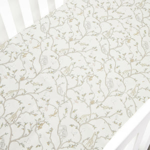 The Gooselings Animal Parade Ivory Crib Sheet is an extra soft cotton sateen sheet for crib mattresses, featuring a delicate pattern of neutral-tone animal designs.