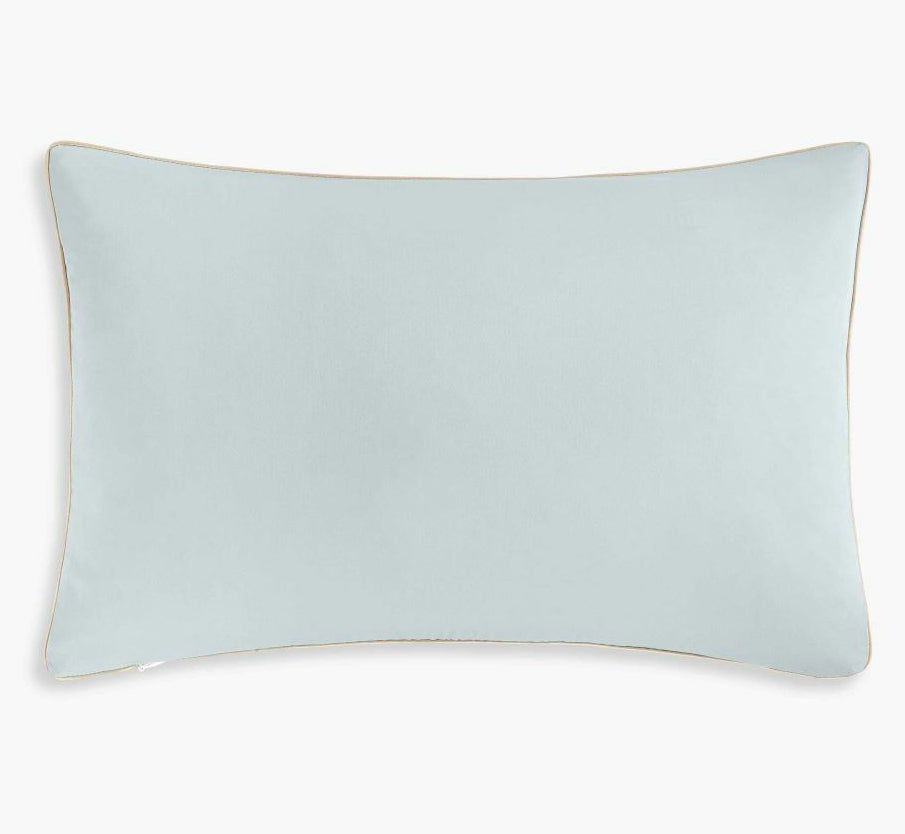 The Gooselings Dino Dreams Toddler Pillow is a rectangular light blue kids’ pillow with beige piping, ideal for children’s bedding, shown on a plain white background.