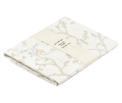 Folded Gooselings Animal Parade Ivory Swaddle, made from 100% cotton with a subtle animal and branch pattern, wrapped in a paper band displaying product and sizing details.