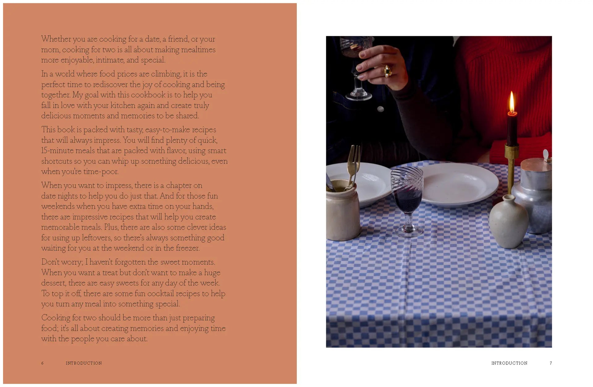 A woman in a dark sweater sits at a table set for “A Meal For Two” by Chronicle Books, featuring a blue checkered tablecloth, wine, cutlery, plates, and a candle, beside another person dressed in red.
