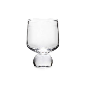 The Simon Pearce Benson Collection features a clear, empty glass with a wide bowl and short, round base, evoking the geometric style of Bauhaus architecture.