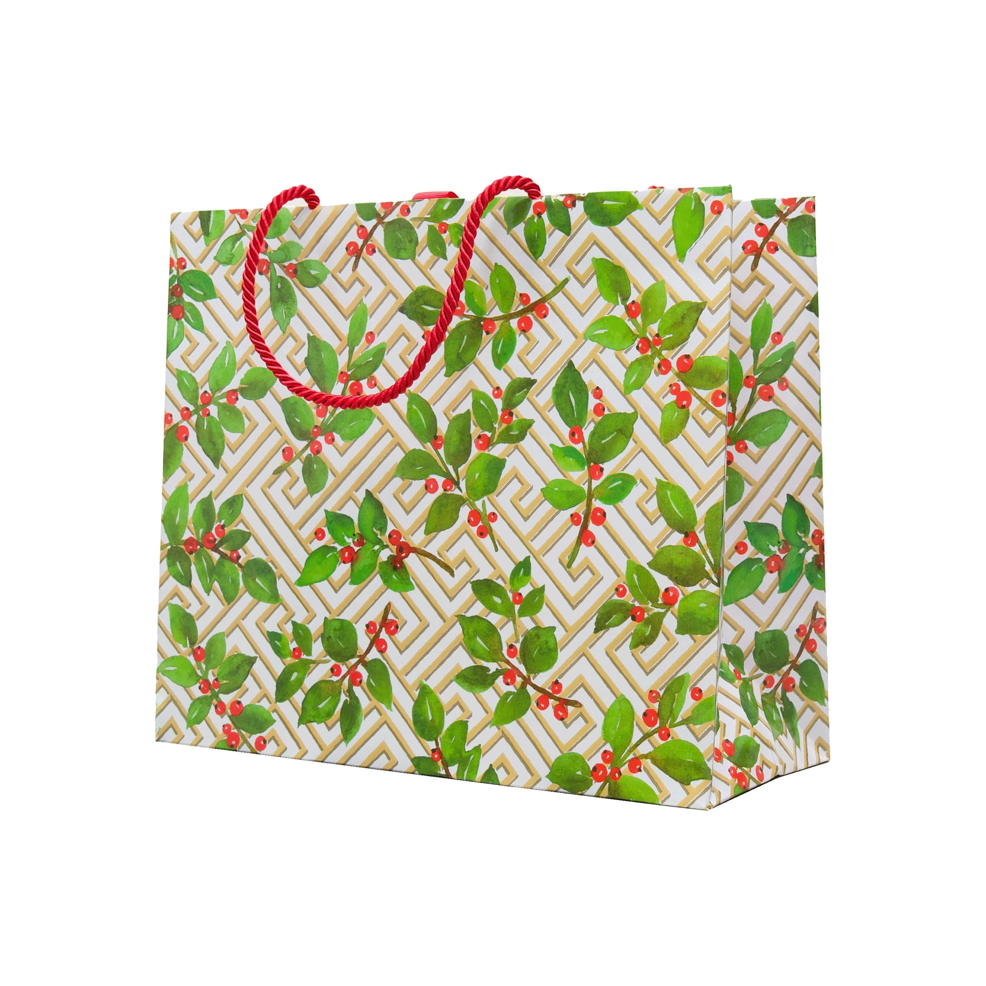 The Caspari Holly and Fretwork White Collection gift bag features a gold geometric pattern, green holly with red berries, and red rope handles—perfect for pairing with festive paper plates or other holiday dinnerware.