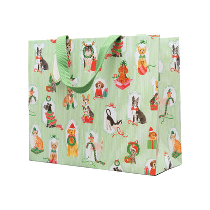 The Presenting Pets Collection large gift bag by Caspari, featuring festive dogs and green handles, pairs perfectly with elegant paper plates or other disposable tableware for your next celebration.