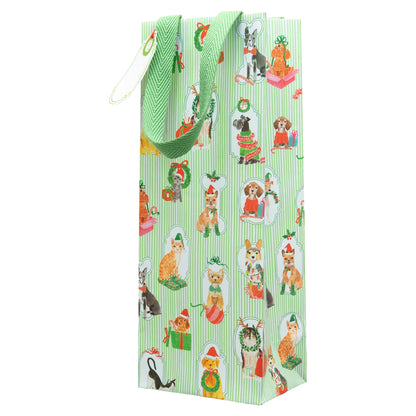 The Caspari Presenting Pets Collection tall gift bag features green vertical stripes and festive cats and dogs in holiday attire, finished with a green ribbon handle—perfect for pairing with Caspari’s elegant paper plates or dinnerware.