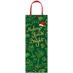 The Caspari Making Spirits Bright Bottle Bag features gold text, holiday illustrations, red handles, and a Santa hat graphic—perfect for gifting bottles in festive, designer style.