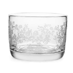 The Simon Pearce Berry Bowl is a clear, lead-free glass piece with a thick base and an etched floral pattern inspired by block print designs around the sides.