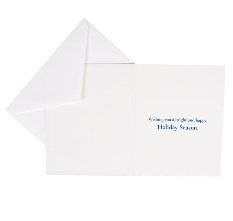 The Caspari Menorah Card Set features an open white FSC-certified holiday card with “Wishing you a bright and happy Holiday Season” in blue on the right, paired with a matching envelope and crafted by a Swiss printer.
