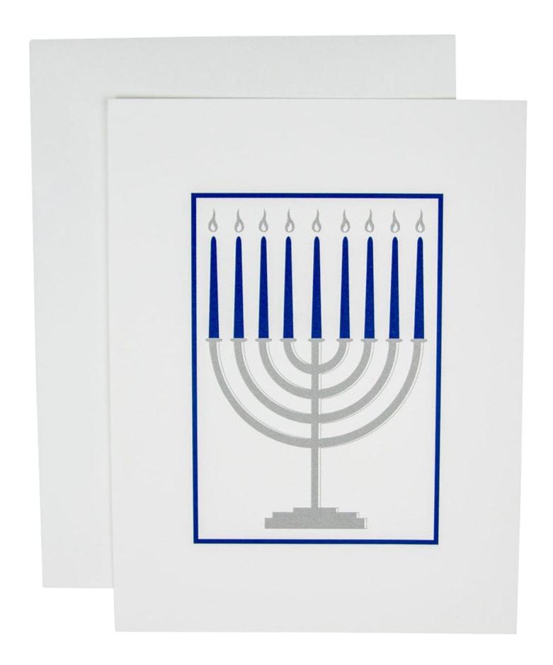 The Caspari Menorah Card Set features a silver menorah with nine blue candles on white, bordered in blue. Printed in Switzerland on FSC-certified paper for an eco-friendly holiday greeting.