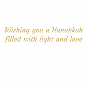 Gold script text on a white background reads: “Wishing you a Hanukkah filled with light and love.” The Menorah and Doves Boxed Card Set by Caspari is printed on FSC-certified cardstock, making it an elegant choice for sending warm wishes with its matching cards and envelopes.