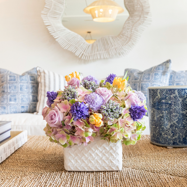 An Live Easter Floral Arrangement from Hive Floral Studio adorns a table in the living room.