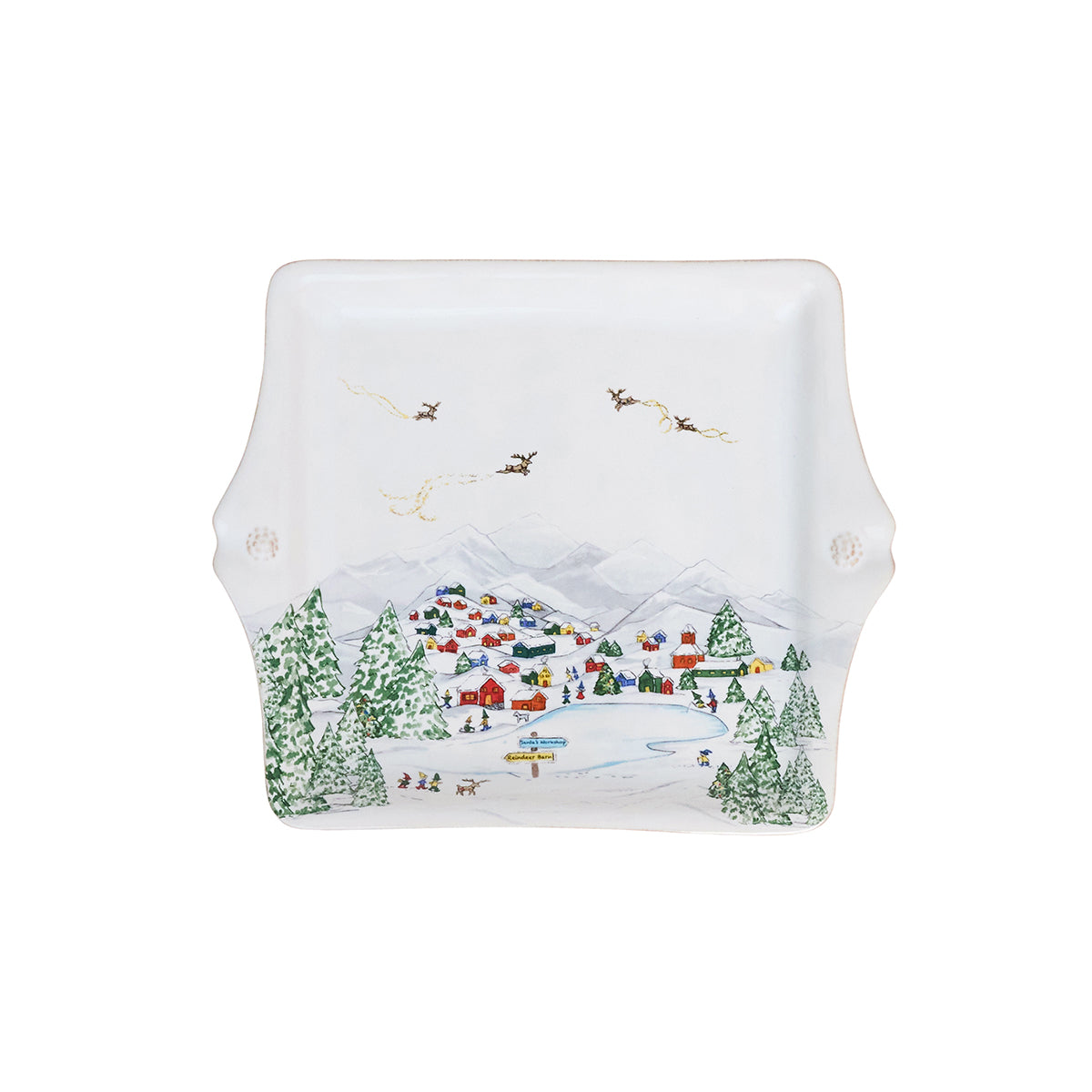 The Juliska Berry & Thread North Pole Dinnerware and Serveware Collection features a square ceramic platter with handles, decorated with a winter village scene, snowy mountains, colorful houses, pine trees, and reindeer.