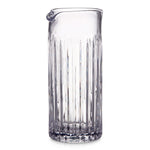 The Montpelier Drinkware Collection by Simon Pearce features a hand-blown glass pitcher with vertical ridges and a small spout—an elegant, premium piece perfect for any setting.