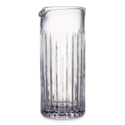 The Montpelier Drinkware Collection by Simon Pearce features a hand-blown glass pitcher with vertical ridges and a small spout—an elegant, premium piece perfect for any setting.
