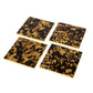 The Caspari Tortoiseshell Lacquer Coaster Set includes four glossy, dark brown and yellow coasters, beautifully displayed on a white background and ready for your favorite coaster holder.