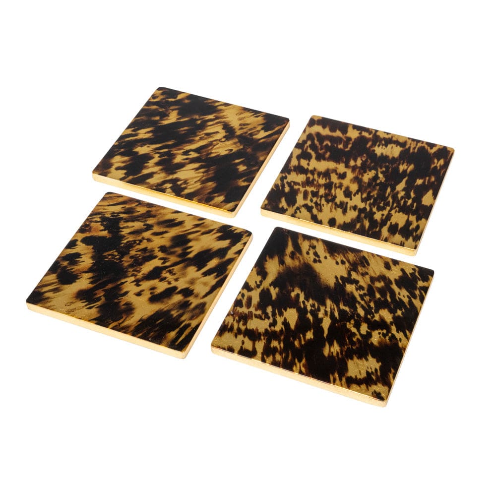 The Caspari Tortoiseshell Lacquer Coaster Set includes four glossy, dark brown and yellow coasters, beautifully displayed on a white background and ready for your favorite coaster holder.