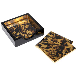 The Caspari Tortoiseshell Lacquer Coaster Set in black and gold includes glossy coasters with a matching holder, adding a chic, organized touch to your tabletop.