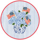 The Flags And Hydrangeas Collection by Caspari features blue hydrangeas and small American flags in a floral vase, set on a picnic table with blue stripes and a red border—ideal for summer celebrations.