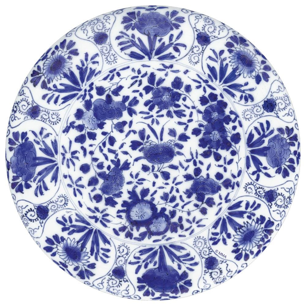 The Delft Blue Collection by Caspari features round porcelain plates with blue floral designs on white, paired with eco-friendly triple-ply napkins—perfect for an elegant table setting.