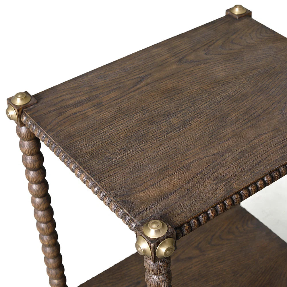 Julian Chichester Bobbin Side Table, a two-tier rustic oak table featuring bobbin legs and aged brass corner accents.