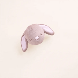 The Foggy Dog Easter Bunny 2-in-1 Bounce Dog Toy, featuring closed eyes and two floppy ears, rests on a plain light background.