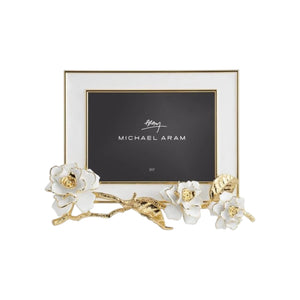 Rectangular photo frame from the Gardenia Collection by Michael Aram, featuring gold forged leaves and white hand-enameled flowers along the bottom and left side.