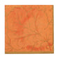 The Caspari Gilded Majolica Coral Collection square orange napkin features a textured leaf and branch pattern with a gold edge—perfect for pairing with decorative paper plates for coordinated disposable tableware.