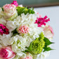 The Live Mother's Day Floral Arrangement by Hive Floral Studio features white hydrangeas, pink roses, green viburnum, and magenta blooms—creating a vibrant bouquet perfect for celebrating mom.