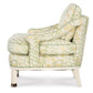Side view of the Highland House Atchison Slipper Chair, upholstered in Botanical Citron fabric with a green and yellow floral leaf pattern, featuring cushioned seat, back, and arms atop smooth white wooden legs.