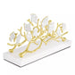 The Michael Aram Butterfly Gingko Gold Vertical Napkin Holder is a handcrafted decorative piece with butterflies on branches and a white base, making it a stunning addition to your table or decor collection.