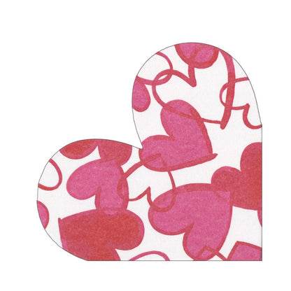 Caspari’s Painted Hearts Luncheon Napkins feature a white background with overlapping red hearts and swirling lines, crafted from biodegradable paper linen.