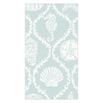 The Caspari Seychelles Aqua Napkin Collection features light blue napkins with white sea life illustrations—seahorse, starfish, sand dollar, coral, and seashells—offering a stylish and eco-friendly beach vibe.
