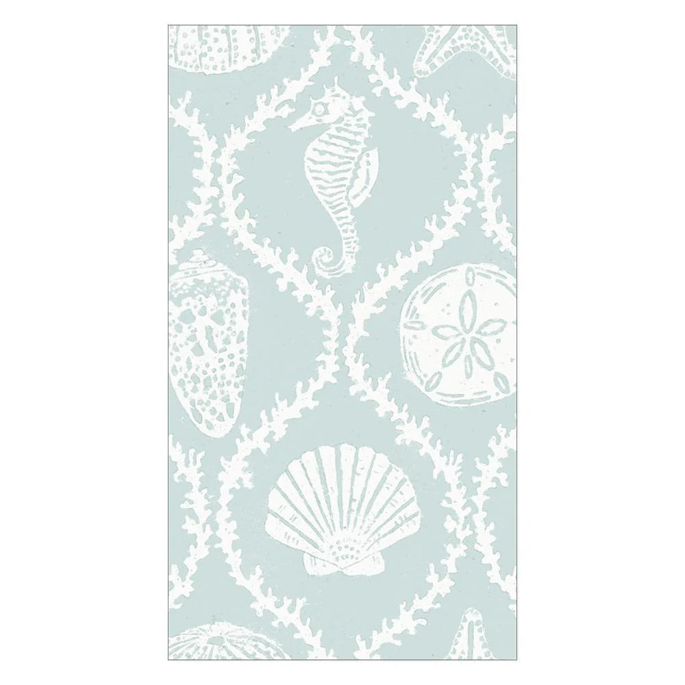 The Seychelles Aqua Collection by Caspari features a light blue rectangular rug with white sea-themed motifs—seahorse, starfish, sand dollar, scallop shell, and coral—ideal to pair with biodegradable napkins for a coastal vibe.