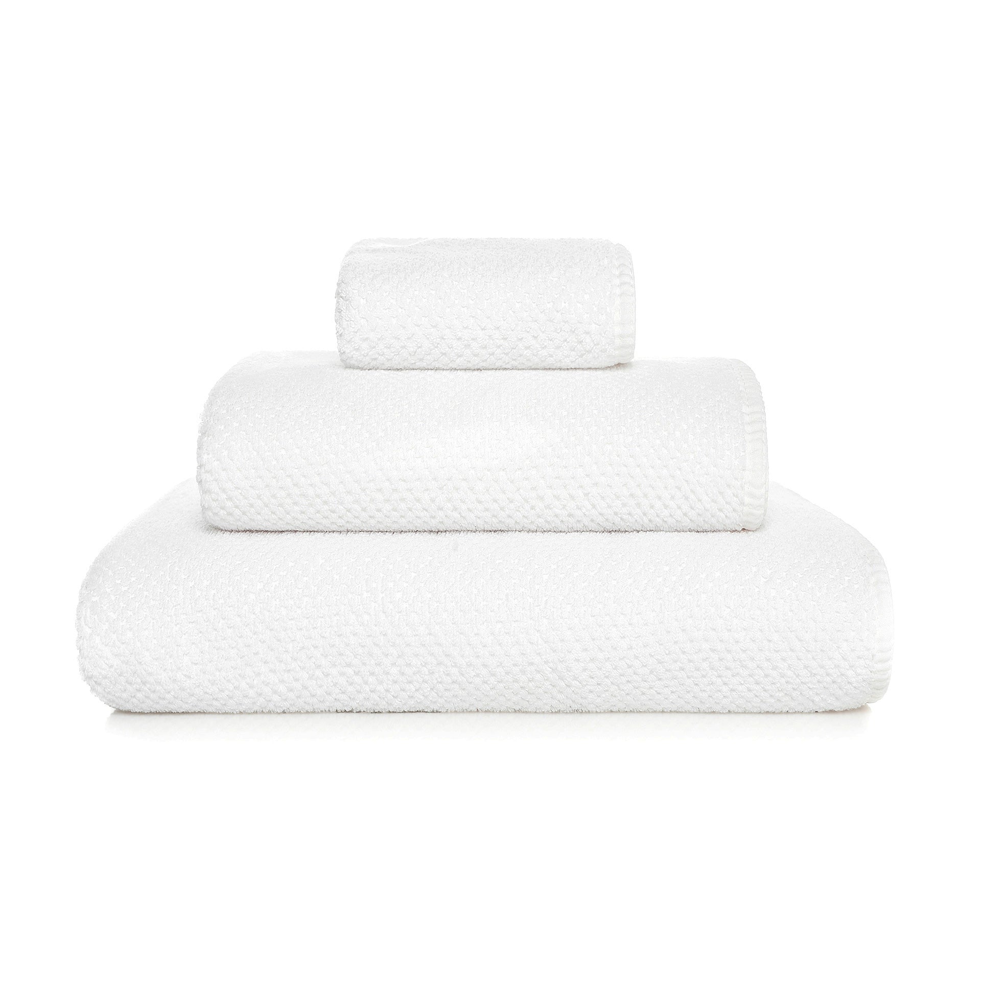 Three neatly folded white towels from the GRACCIOZA Bee Waffle Bath Collection, crafted from soft combed cotton in different sizes, are stacked atop one another against a plain white background.