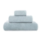 Three neatly folded blue towels from the GRACCIOZA Bee Waffle Bath Collection are stacked atop each other against a white background.