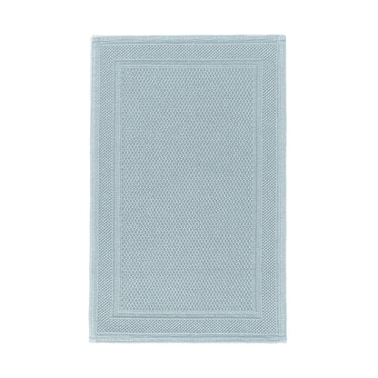 The GRACCIOZA Bee Waffle Bath Collection features a rectangular light blue combed cotton rug with a honeycomb texture and subtle double border, shown on a white background.