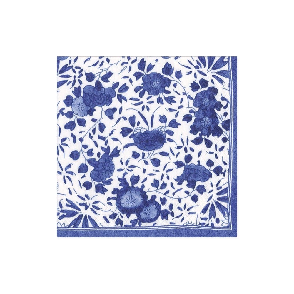 The Delft Blue Collection by Caspari features a white square napkin with a blue floral pattern and border, crafted from eco-friendly, biodegradable triple-ply material for both elegance and sustainability.