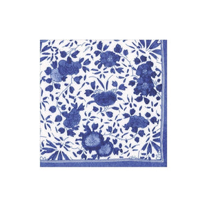 The Delft Blue Collection by Caspari features a white square napkin with a blue floral pattern and border, crafted from eco-friendly, biodegradable triple-ply material for both elegance and sustainability.