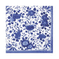 Part of Caspari's Delft Blue Collection, this square textile features a blue and white floral pattern with stylized flowers and leaves and a geometric border—crafted from biodegradable materials for an eco-friendly touch.
